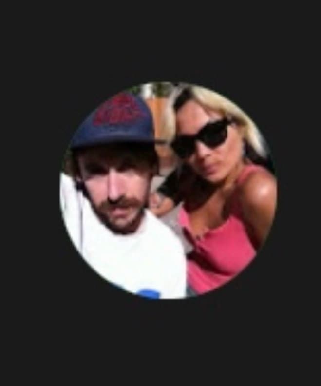 Man in a blue cap and mustache next to a woman in a pink top.